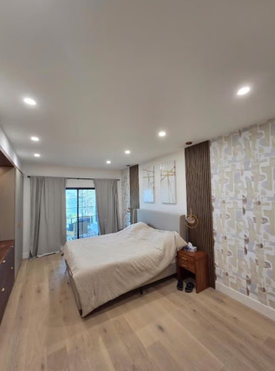 Bright bedroom with smooth painted ceiling, walls and feature panelling